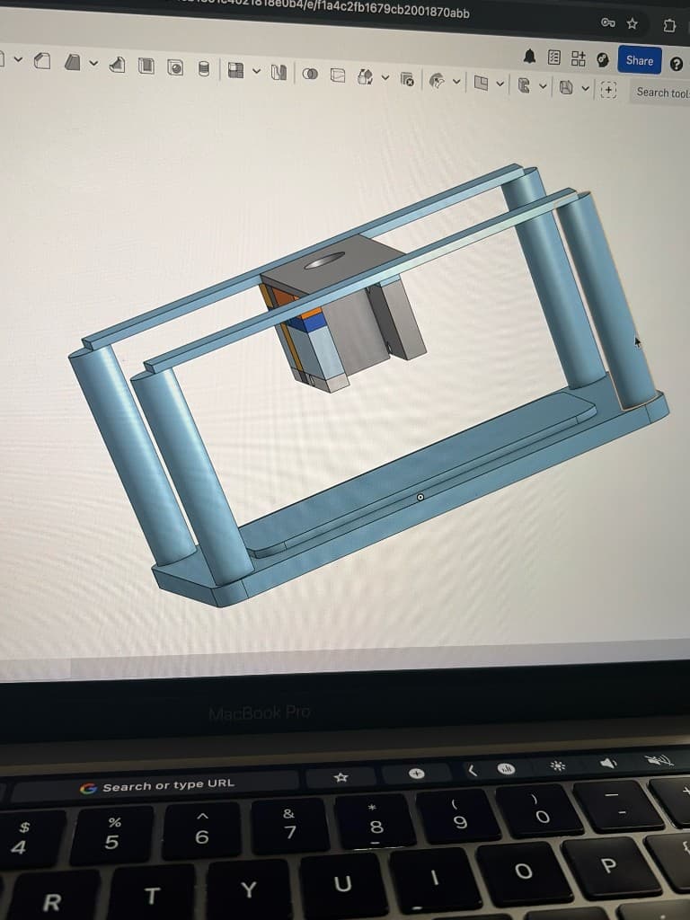 Onshape CAD model of a custom piezoelectric test rig on a laptop screen