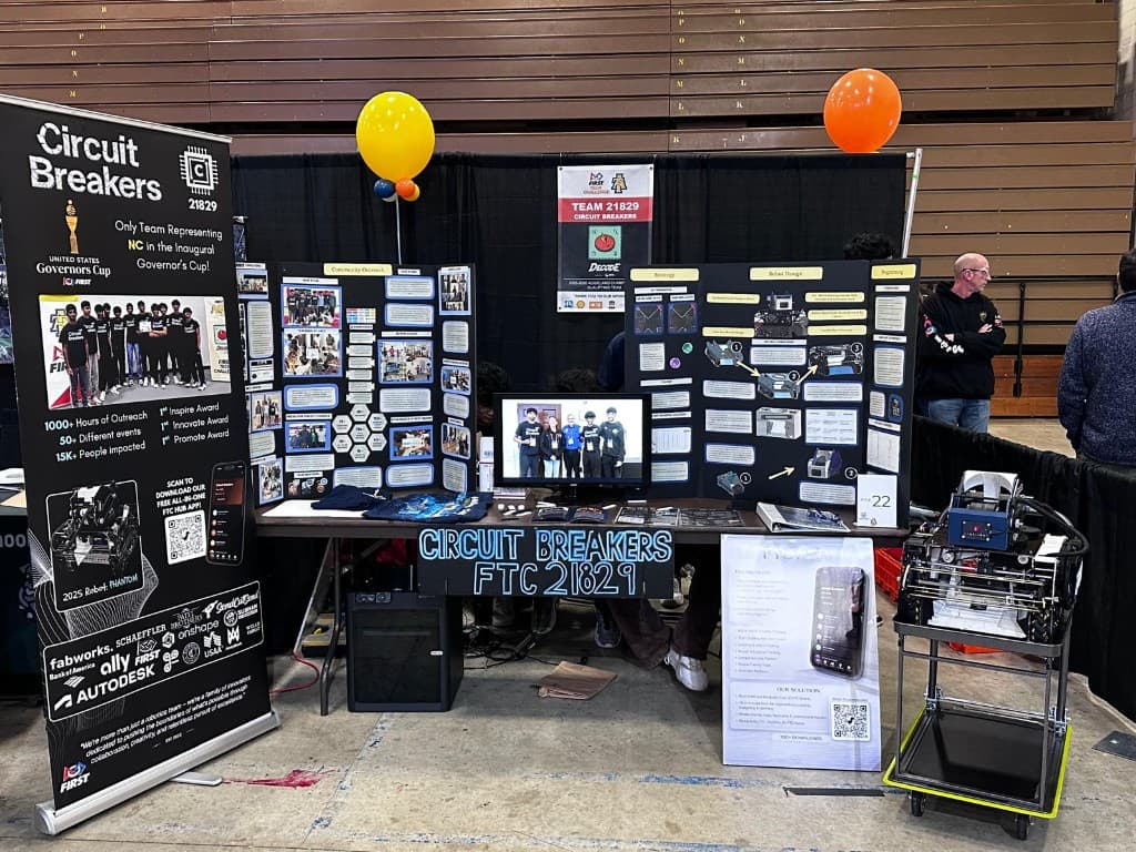 Circuit Breakers FTC 21829 competition booth at Governor's Cup with PHANTOM robot, outreach boards, and FTC Hub app display